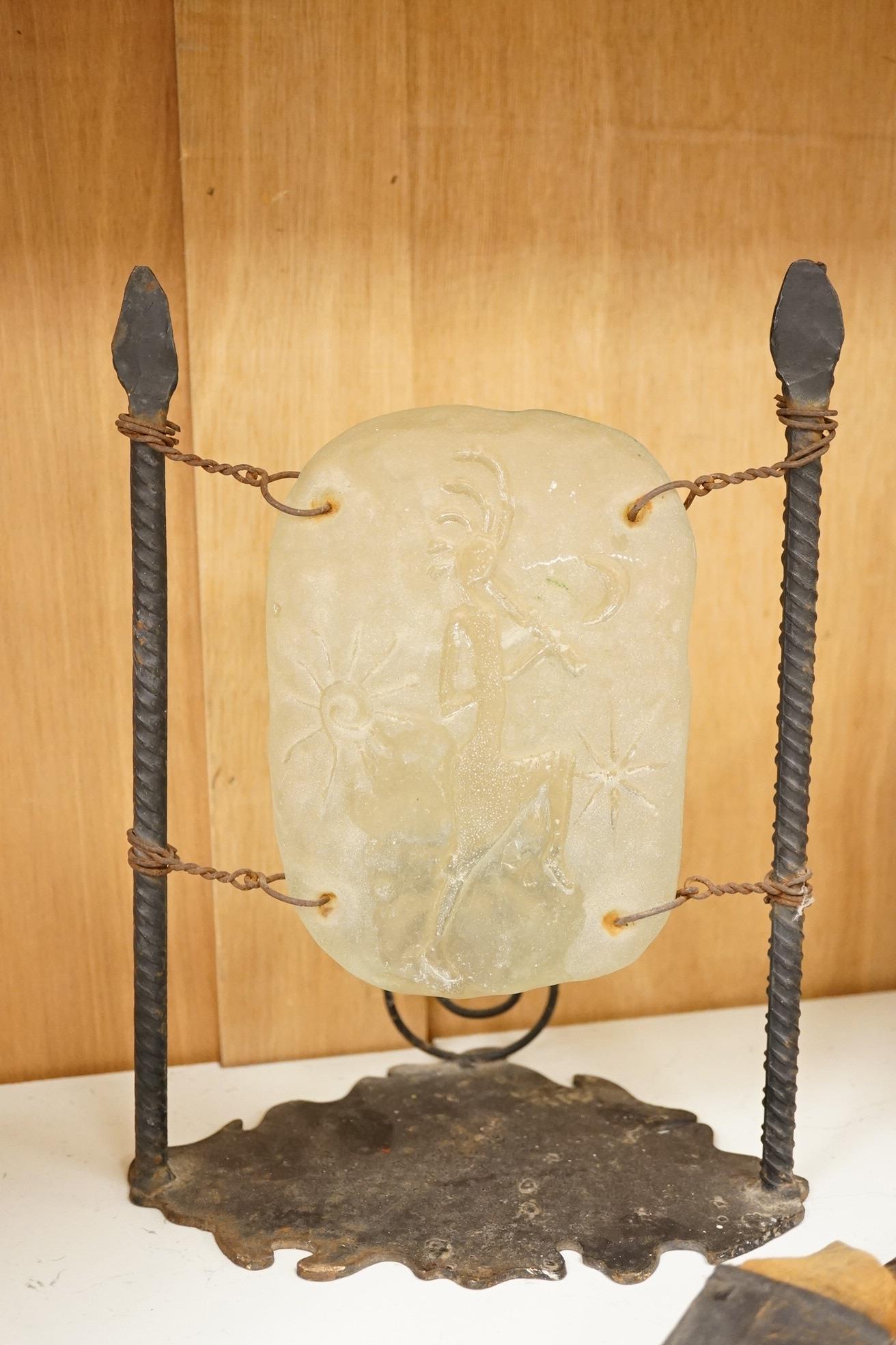 An Indian Kukri with brass mounted wooden handle its leather sheath, and a Moroccan Jambiya, together with a hardstone and wrought iron candle stand